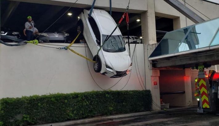 6336f130 lexus dangles over parking garage 6